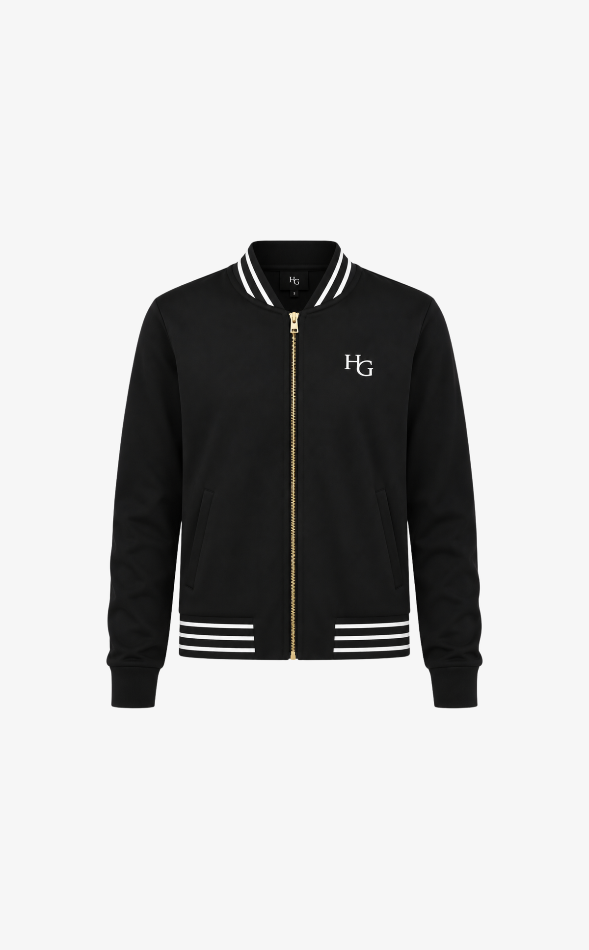 A black varsity-style jacket with a gold front zipper, white striped ribbed collar, cuffs, and hem, featuring a white embroidered 'HG' logo on the left chest, shown against a plain white background.