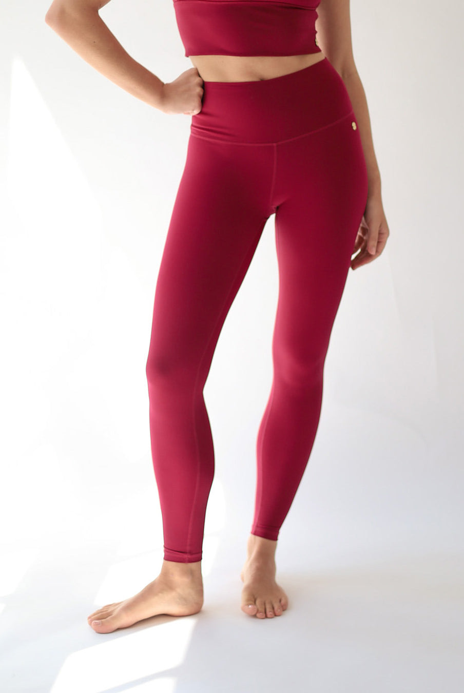 Person wearing red leggings on a white background
