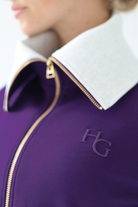House of Gravity Turtleneck Zip Cardigan in Plum, close-up of the sculpted light grey funnel collar, gold-tone zipper, and tonal HG logo detail.