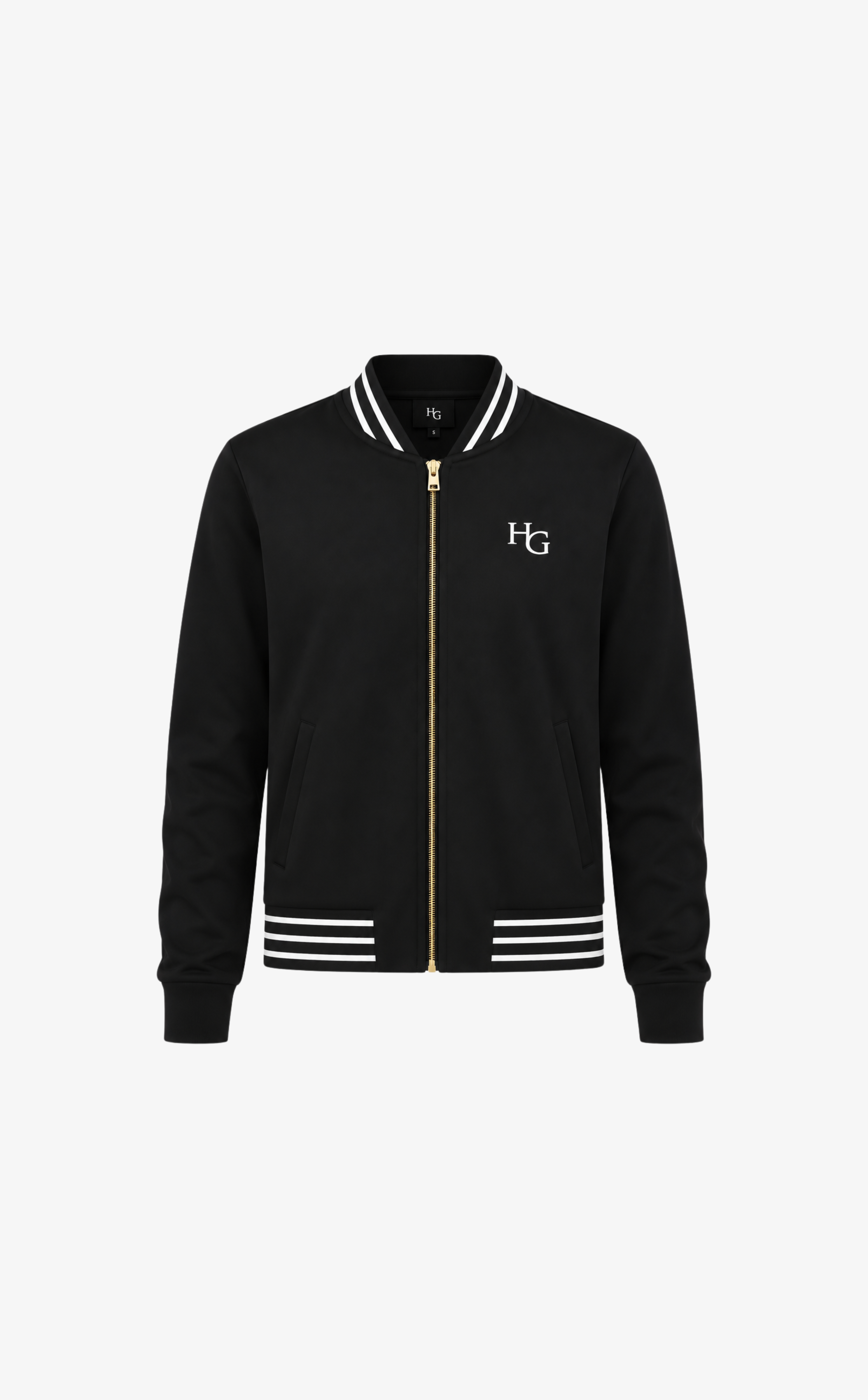 A black varsity-style jacket with a gold front zipper, white striped ribbed collar, cuffs, and hem, featuring a white embroidered 'HG' logo on the left chest, shown against a plain white background.