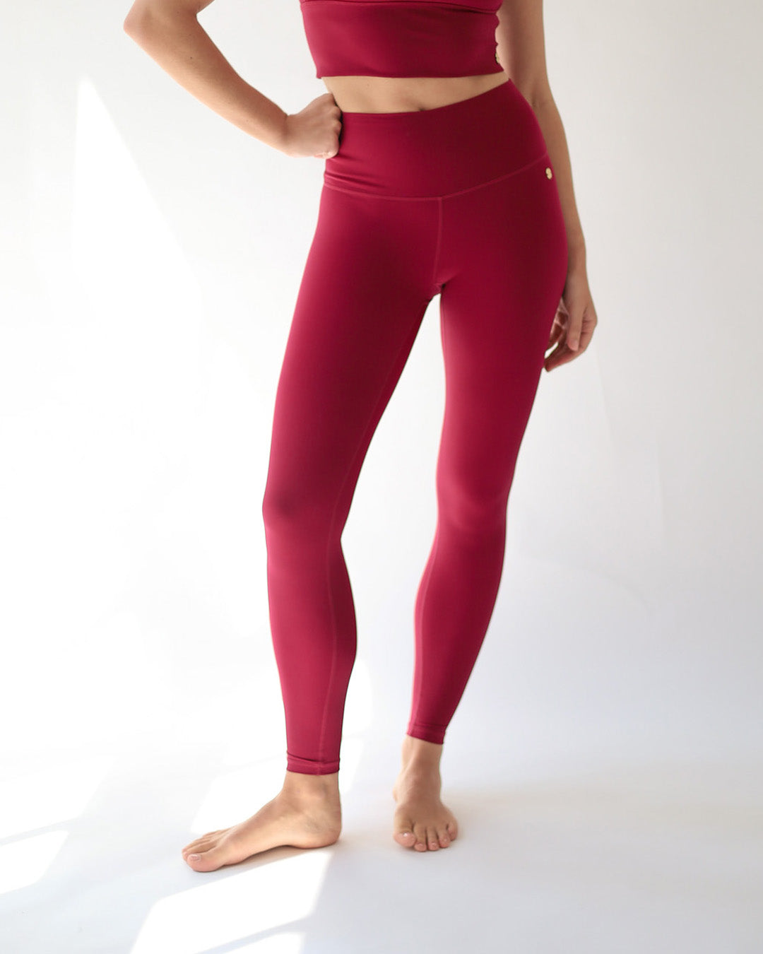 Person wearing red leggings on a white background