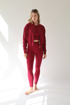 Showcasing a sophisticated Deep Ruby Red activewear set, this look blends feminine strength, modern style, and performance-driven comfort against a clean white backdrop.